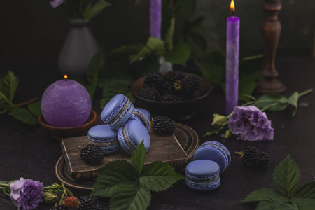 Violet macarons and blackberries on dark green backgroundの写真素材
