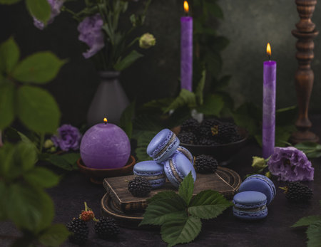 Violet macarons and blackberries on dark green backgroundの写真素材
