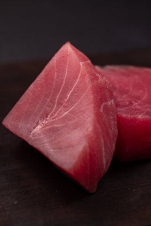 Two raw red tuna steaks featuring a vibrant color and fresh texture, perfect for gourmet dishes, healthy cuisine, and high quality seafood preparationの写真素材