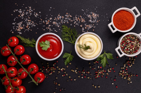 Various condiments including vibrant red ketchup and creamy mayonnaise are presented with fresh...