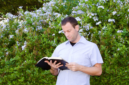 Man reading God's Word outside on a beautiful day.