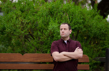 Optimistic man sitting on a bench.の写真素材