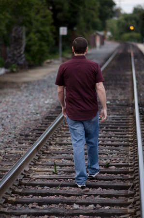 Man walking the railroad tracks alone.の写真素材
