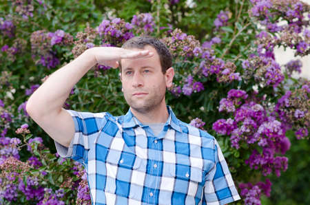 Man with hand on his forehead looking out.の写真素材