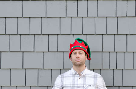 Lack of Christmas cheer. Man in a Christmas hat with no expression.の写真素材