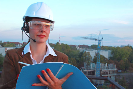 Female engineer manages building operations and records important data