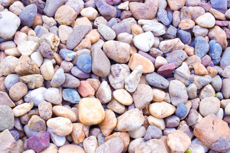 Many stones of various colors as a background in the full frame