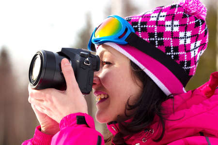 Smiling young woman shoots winter's nature, All Winter's Magic, Photographyの写真素材