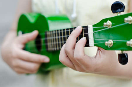 Closeup of a woman playing ukuleleの写真素材