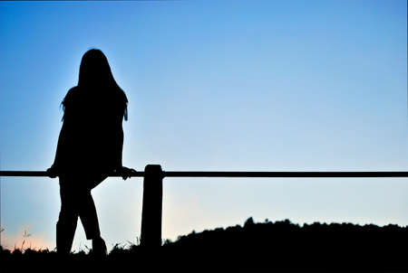 silhouette of a woman on a mountainの写真素材