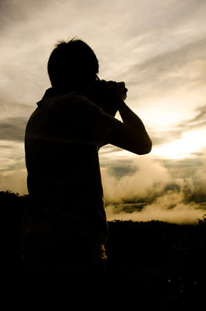 silhouette of a photographer の写真素材