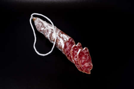 Finely chopped sausage on black background close-up 2018の写真素材