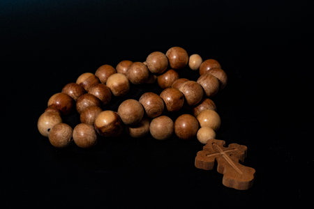 Rosary with a cross on a black background