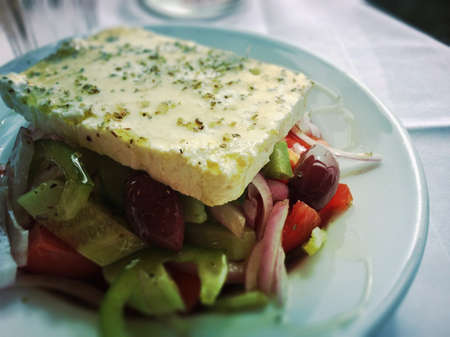 French salad with feta cheese and vegetables.の写真素材