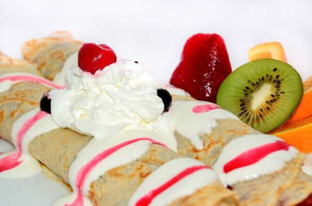 Fried crepes with sour cream and fruit for breakfast.の写真素材
