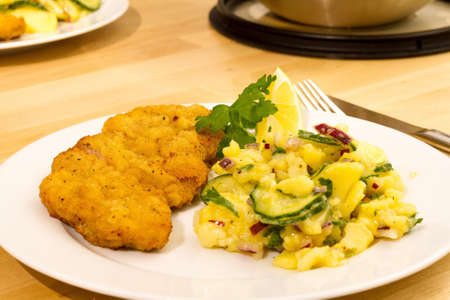 Chicken chop in batter and delicious salad side dish.の写真素材