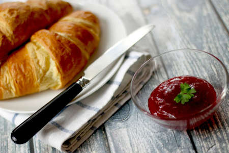 Delicious crispy croissant and tomato sauce for breakfast.の写真素材