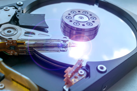 Opened hard drive with a read head with a highlight on it