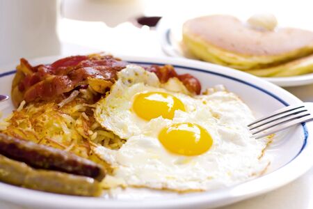 two roasted eggs with fried ham and baconの写真素材