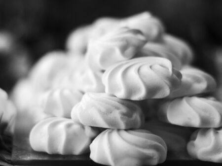 A pile of white and sweet marshmallows in black and whiteの写真素材