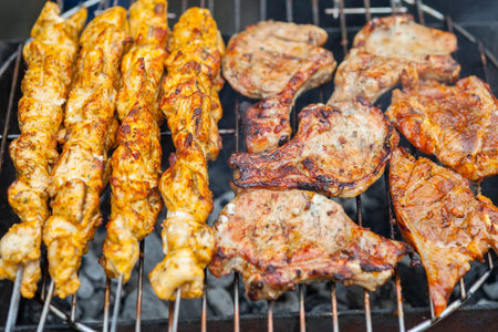 BBQ - Assorted meat on an outdoor BBQ grill  Close-up 