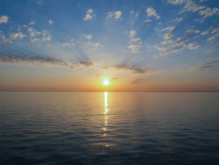 Sunrise over the river. Sunrise bursting the clouds.の写真素材