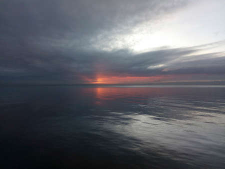 Sunrise into the storm. Sunrise over the sea.の写真素材