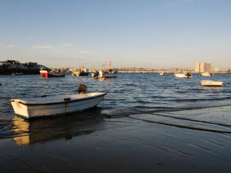 Fishing boats floating anchored in calm waters.のeditorial素材