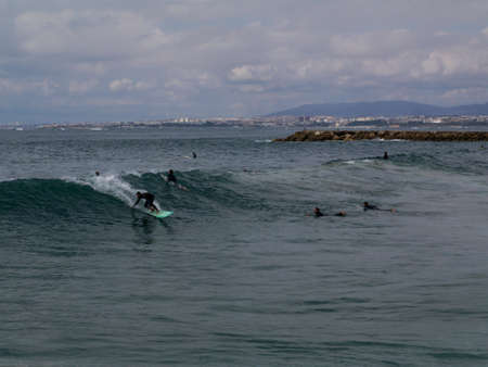 Group of surfers waiting for waves on 10 of October in Costa da Caparica, Portugal.のeditorial素材