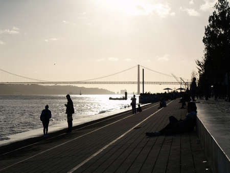 People relaxing by the river.の写真素材