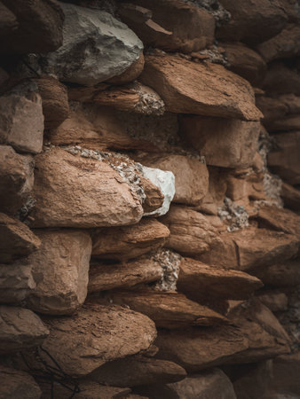 Background of stone wall texture. Close up. Selective focus. Toned.の写真素材