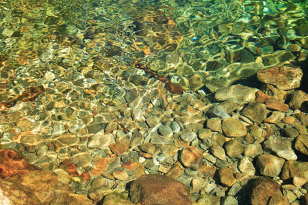Green water in the mountain lake in italian Alps