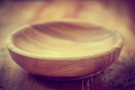 Wooden bowl on the wood with vintage effectの写真素材