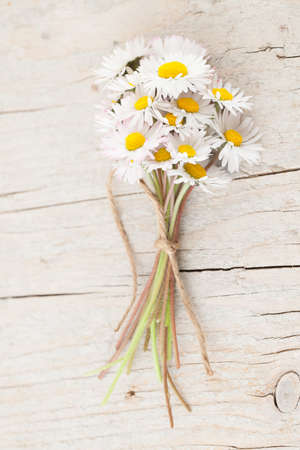 Bouquet of daisies on white wooden backgroundの写真素材