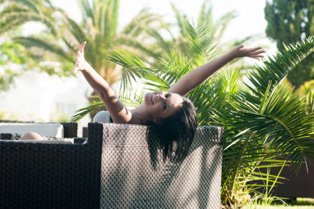Young smiling woman sitting on the chairの写真素材