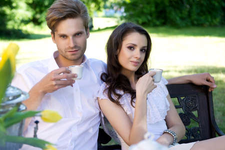 Young couple enjoying lunch in the gardenの写真素材