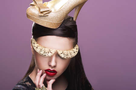 Sexy woman woth gold shoe on headの写真素材