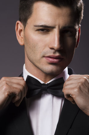 Close-up portrait of a young handsome man with bow tie