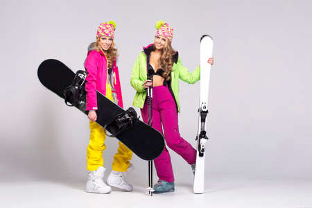 Two beauty women with winter equipmentの写真素材