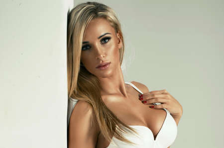 Sexy blonde woman in white lingerieの写真素材