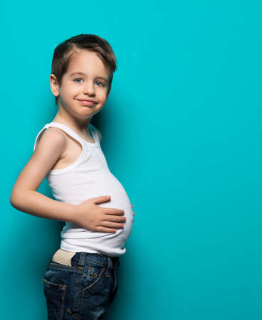 Small happy boy with big tummyの写真素材