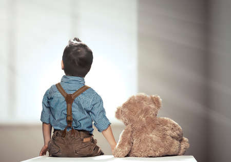 Rear view of small boy with bearの写真素材