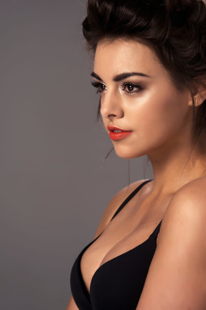 Fashion portrait of a beautiful brunette woman with shot hairstyleの写真素材