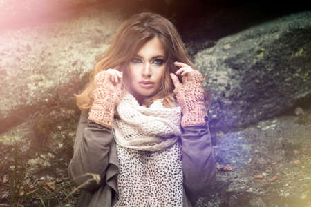 Beautiful elegant woman in a park in autumnの写真素材