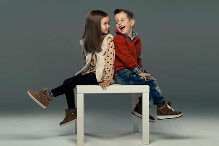 A portrait of a laughing girl and a smiling boy. Autumn styleの写真素材