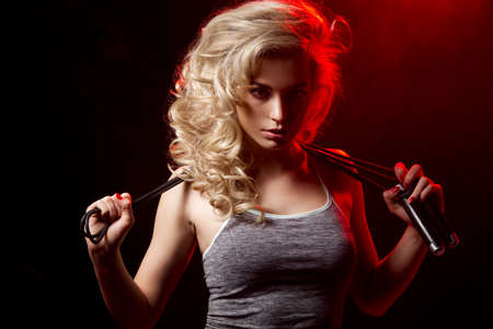 Fitness woman standing with weightsの写真素材