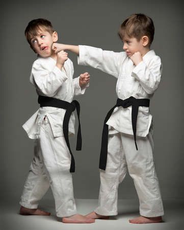 Little boys in uniform practicing judo. The same person two timesの写真素材