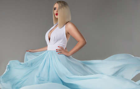 young beauty woman in fluttering dress.の写真素材