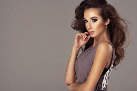 Beautiful brunette woman posing in studioの写真素材