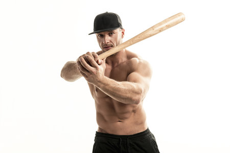 Close-up portrait of muscular man posing with a bat